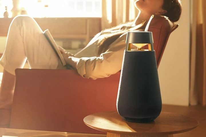 LG XBoom 360 X03 speaker in front of reclined woman.