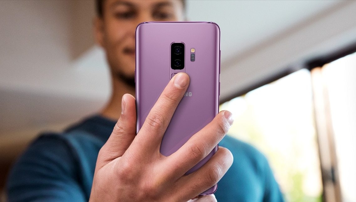 Photo dâune personne tenant un Galaxy S9  pour montrer le positionnement du capteur dâempreinte digitale.